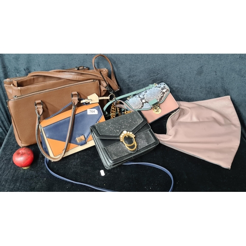 764 - A selection of four stylish ladies handbags including a large deep Ecco example.