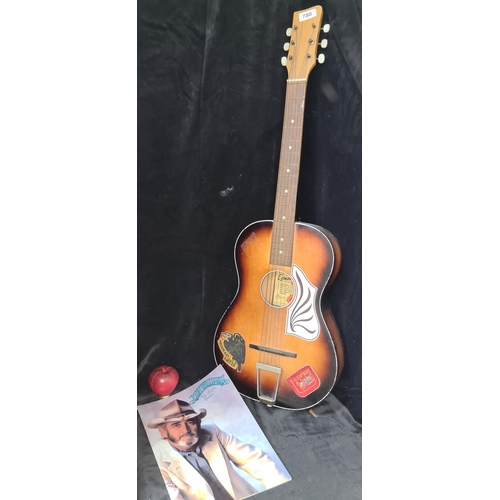 780 - A Dutch made Egmond six string acoustic guitar along with Don Williams picture book.