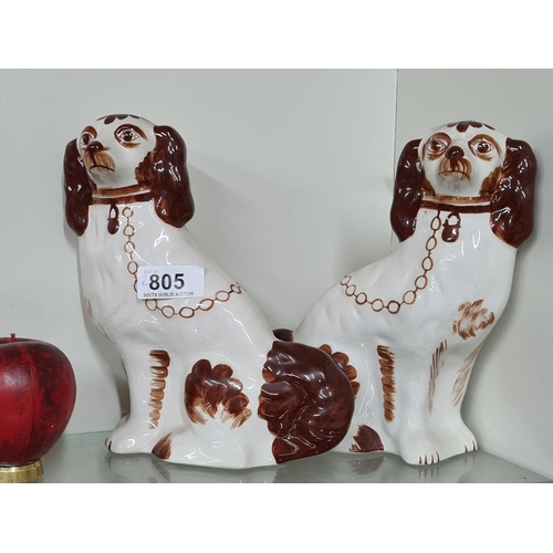 805 - A pair of hand painted Staffs England dog figurines.