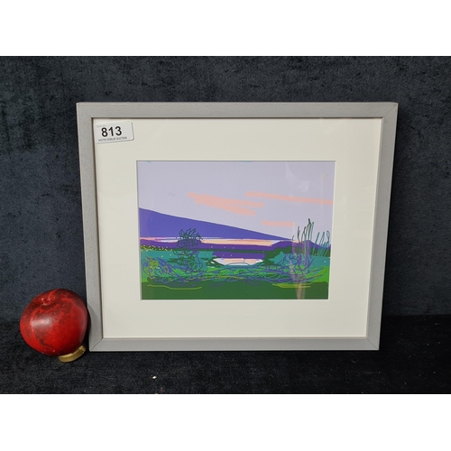 813 - An original serigraph. Features a colourful landscape scene of mountains with a field of greenery in... 