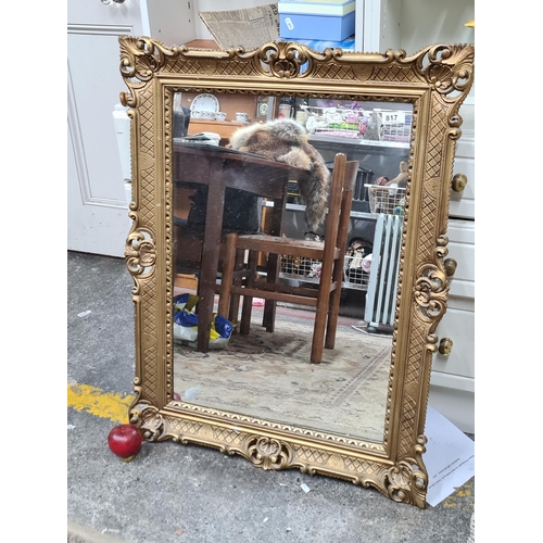 817 - A large decorative mantel mirror housed in a gilt Chippendale style frame. MM: 69cm x 89cm