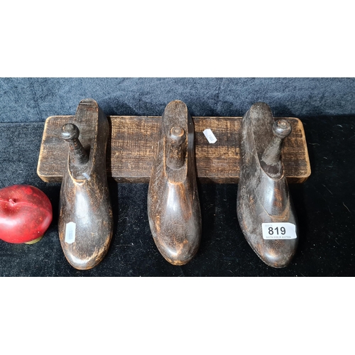 819 - A decorative cobbler's three shoe lasts coat rack.