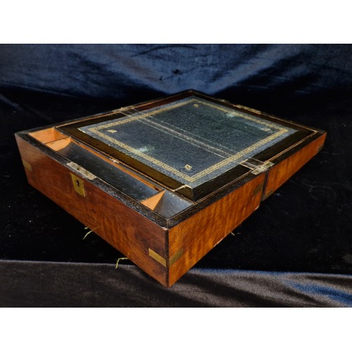 129 - An antique walnut writing slope with gilt embossed slope and brass cartouche and corners.