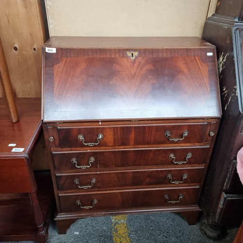 466 - A quality vintage writing desk with four drawers featuring brass handles, bracket feet and nice done... 