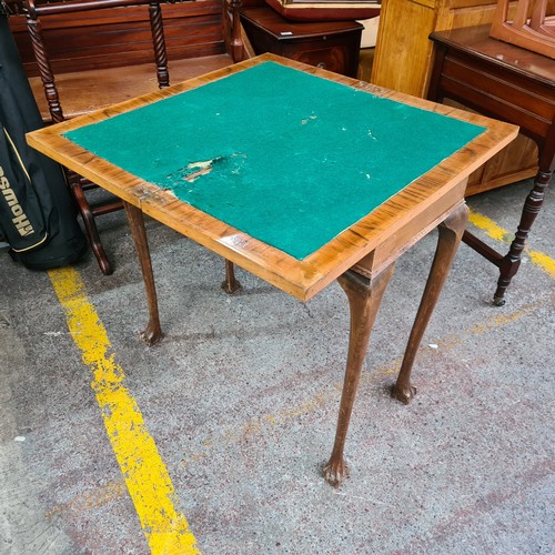 444 - An antique card games table with lion paw feet, original green baize and swivel top opening to revea... 