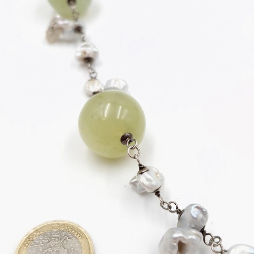 823 - Star Lot: A fabulous antique Chinese natural pearl and jade necklace with jade carved ball with a Ch... 