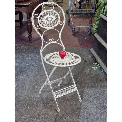 873 - A good heavy decorative folding patio chair.