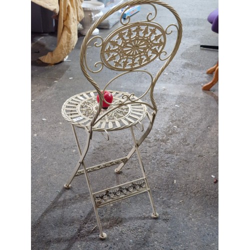 873 - A good heavy decorative folding patio chair.