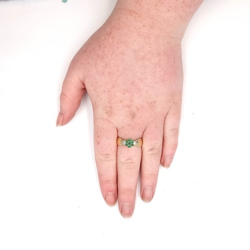 52 - A vintage heavy nine carat gold wide band emerald daisy ring. Size - Q 1/2. Weight - 3.51 grams.