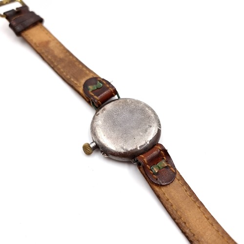 530 - An antique military wristwatch with leather strap. Item in need of attention - face without glass at... 