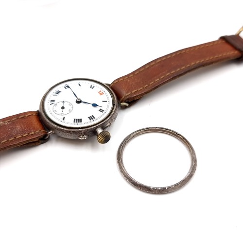 530 - An antique military wristwatch with leather strap. Item in need of attention - face without glass at... 