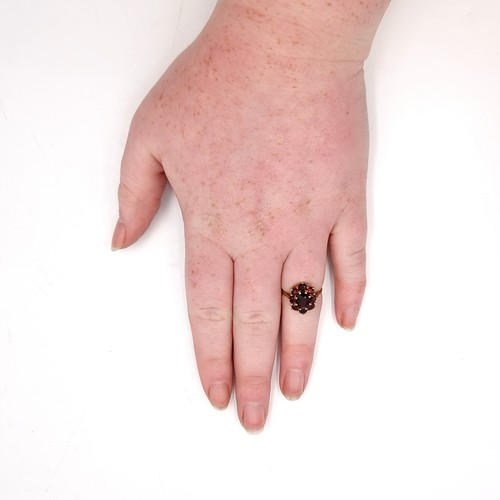 639 - Star Lot : A nine carat gold 375 garnet stone cluster ring. Size - L. Weight - 2 grams. Boxed.