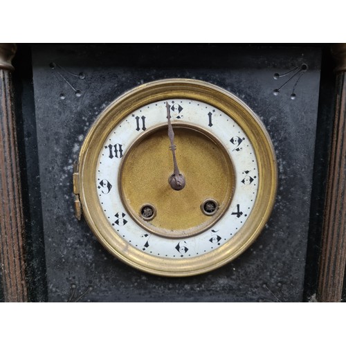 759 - A large heavy antique 8 day slate mantel clock in a neoclassical style featuring Roman like figures ... 