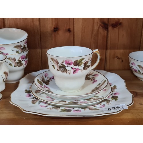 898 - A 40 piece Arklow pottery tea service featuring cups, saucers, side plates, sandwich plate, creamer ... 