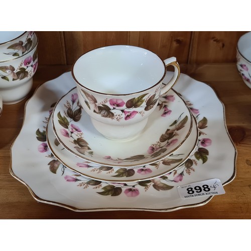 898 - A 40 piece Arklow pottery tea service featuring cups, saucers, side plates, sandwich plate, creamer ... 