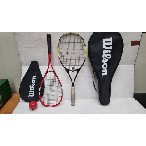 411 - A Wilson Tennis racket and Wilson squash racket. Includes red and black models, original zippered lo... 