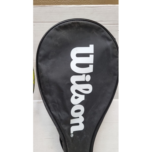 411 - A Wilson Tennis racket and Wilson squash racket. Includes red and black models, original zippered lo... 