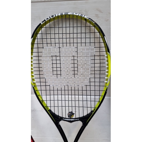 411 - A Wilson Tennis racket and Wilson squash racket. Includes red and black models, original zippered lo... 