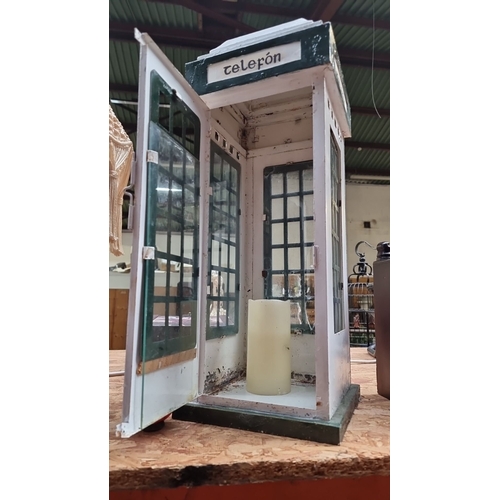 416 - A miniature Irish telephone booth candle lantern, painted metal and glass with functional door. Incl... 