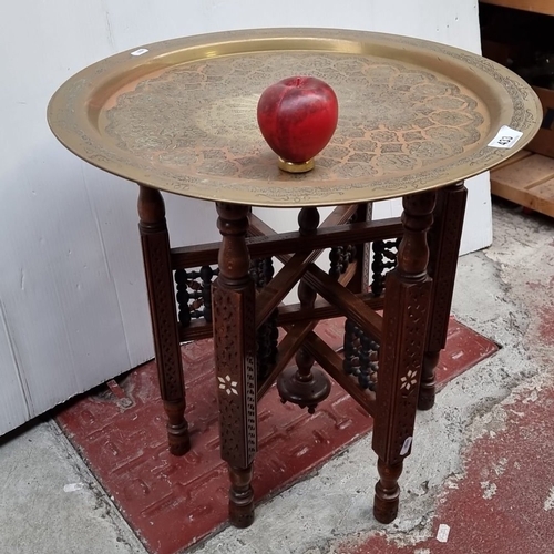 433 - Brass tray table with folding inlaid wood base, engraved with Moorish-inspired motifs. From the mid-... 