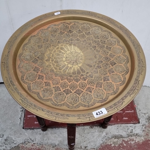 433 - Brass tray table with folding inlaid wood base, engraved with Moorish-inspired motifs. From the mid-... 