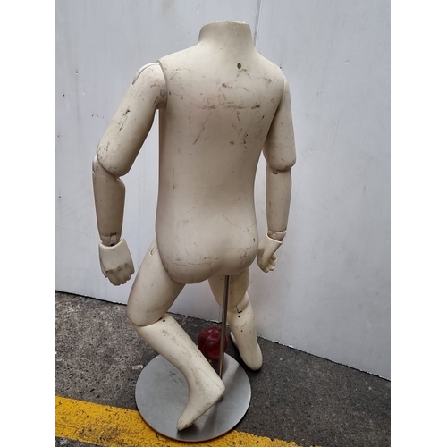 438 - Vintage articulated child mannequin from the mid-20th century, made of fiberglass or composite mater... 