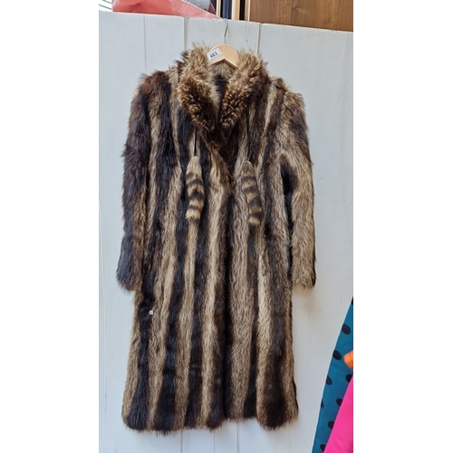 463 - A beautiful vintage musquash fur coat, featuring striped pelts and decorative tails. Fur is in lovel... 