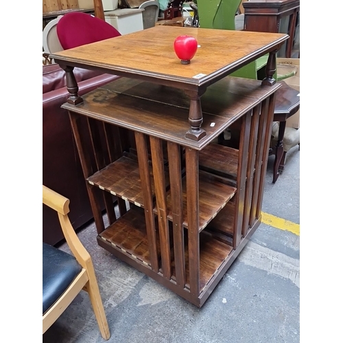 466 - A very handsome vintage mahogany revolving bookshelf. Features slotted shelving, numbered compartmen... 