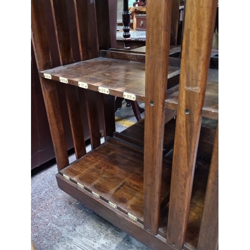 466 - A very handsome vintage mahogany revolving bookshelf. Features slotted shelving, numbered compartmen... 