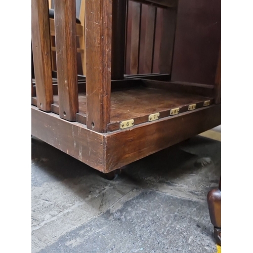 466 - A very handsome vintage mahogany revolving bookshelf. Features slotted shelving, numbered compartmen... 