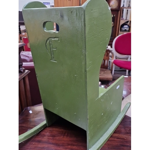 467 - Wooden rocking chair, painted green, from the mid-20th century. It features a cutout handle and a ca... 