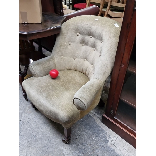 470 - Star Lot : Late Victorian upholstered armchair with button-tufted back, rolled arms, and mahogany ca... 