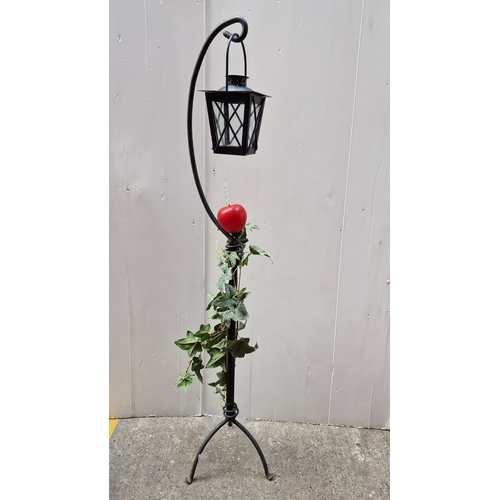 479 - Decorative wrought-iron floor lantern with glass-paneled housing