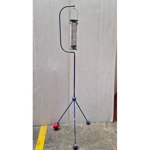 488 - Free-standing bird feeder with a metal tripod base, mesh seed tube, and 