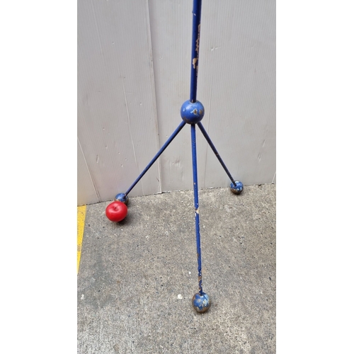 488 - Free-standing bird feeder with a metal tripod base, mesh seed tube, and 