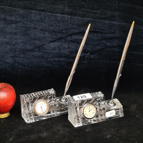 125 - A pair of Waterford Crystal quartz desk clocks and pens. In good condition with acid marks to base.