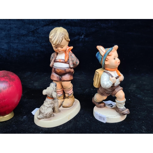 134 - Two vintage West German Goebel figures including a charming 1955 Boy with Dog stamped 317 and a Boy ... 