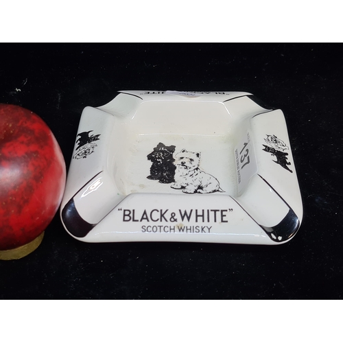 137 - A 1960's ceramic Black & White Scotch Whisky branded ashtray by James Green & Nephew Ltd. Bears gree... 