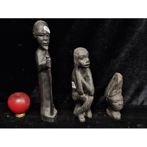 225 - A trio of carved ebony African figures.