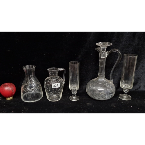 226 - A selection of vintage glassware including a carafe, claret jug decanter with stopper, and a pitcher... 