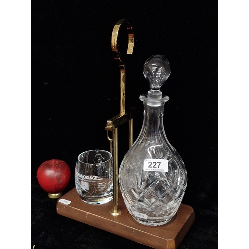 227 - A handsome whiskey decanter and glass set with wooden and brass stand. Glass in good condition.