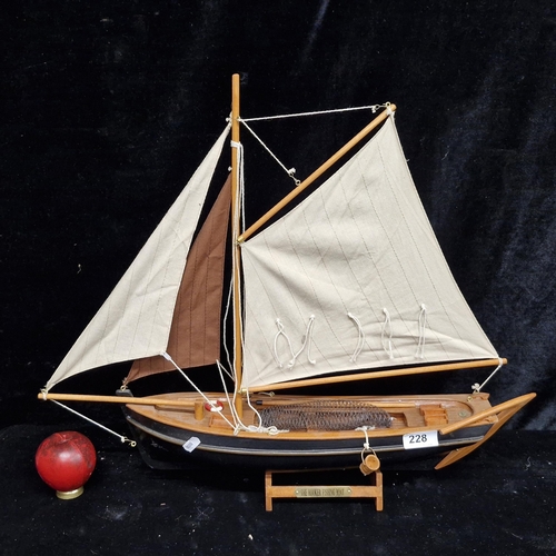 228 - A large hand crafted wooden model of 'The Hooker Fishing Boat'. With cotton sails and a stand, great... 