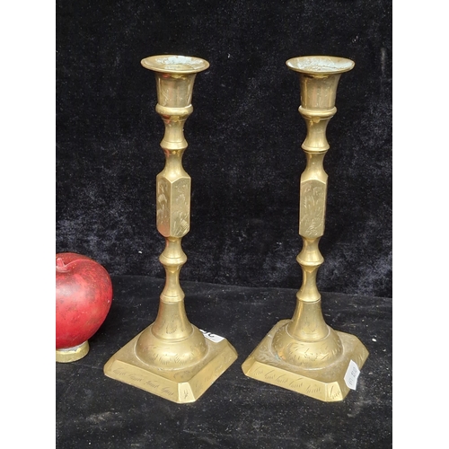 264 - A very nice pair of brass candlesticks featuring hand engravings.