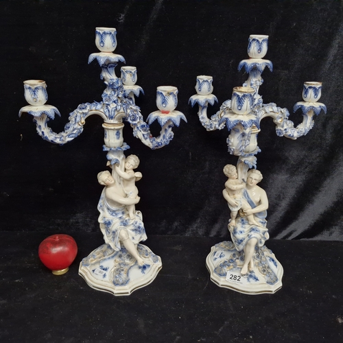 282 - Star lot :A fabulous pair of mid 19th century German Sitzendorf porcelain candelabras with figural d... 