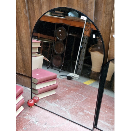 362 - A large sleek and stylish arch shaped mirror housed in a matte black frame. MM 100cm x 70cm.