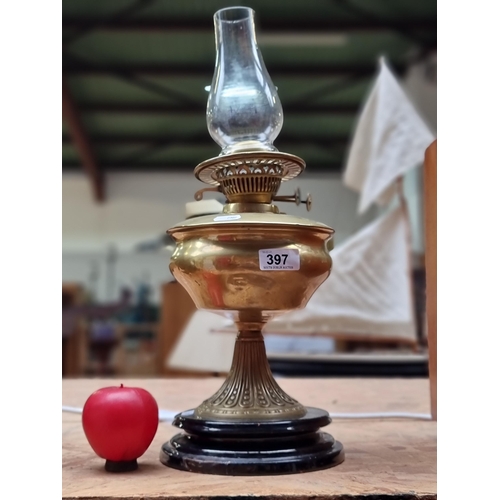 397 - A brass Duplex oil lamp and glass chimney.