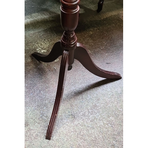 635 - Mahogany tilt-top tripod table, early 20th century, features a turned column and delicately splayed ... 