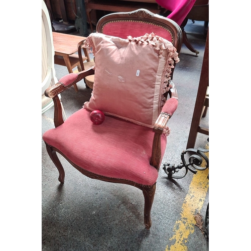 666 - French Louis XV-style armchair with carved walnut frame, red upholstery, and decorative brass nailhe... 