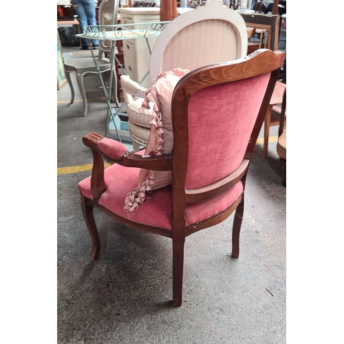 666 - French Louis XV-style armchair with carved walnut frame, red upholstery, and decorative brass nailhe... 