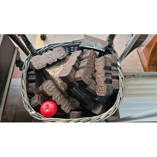 671 - Vintage wicker basket filled with briquettes, From the Drawing room of Woodley Park House. .